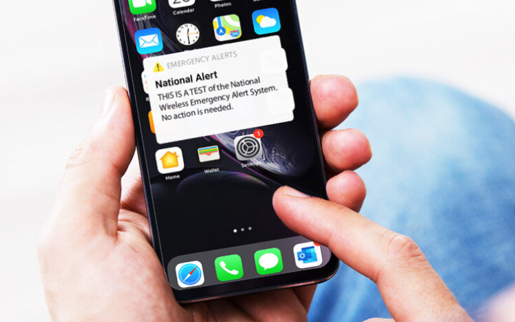 iPhone with screen alert: National Alert. THIS IS A TEST of the National Wireless Emergency Alert System. No action is needed.